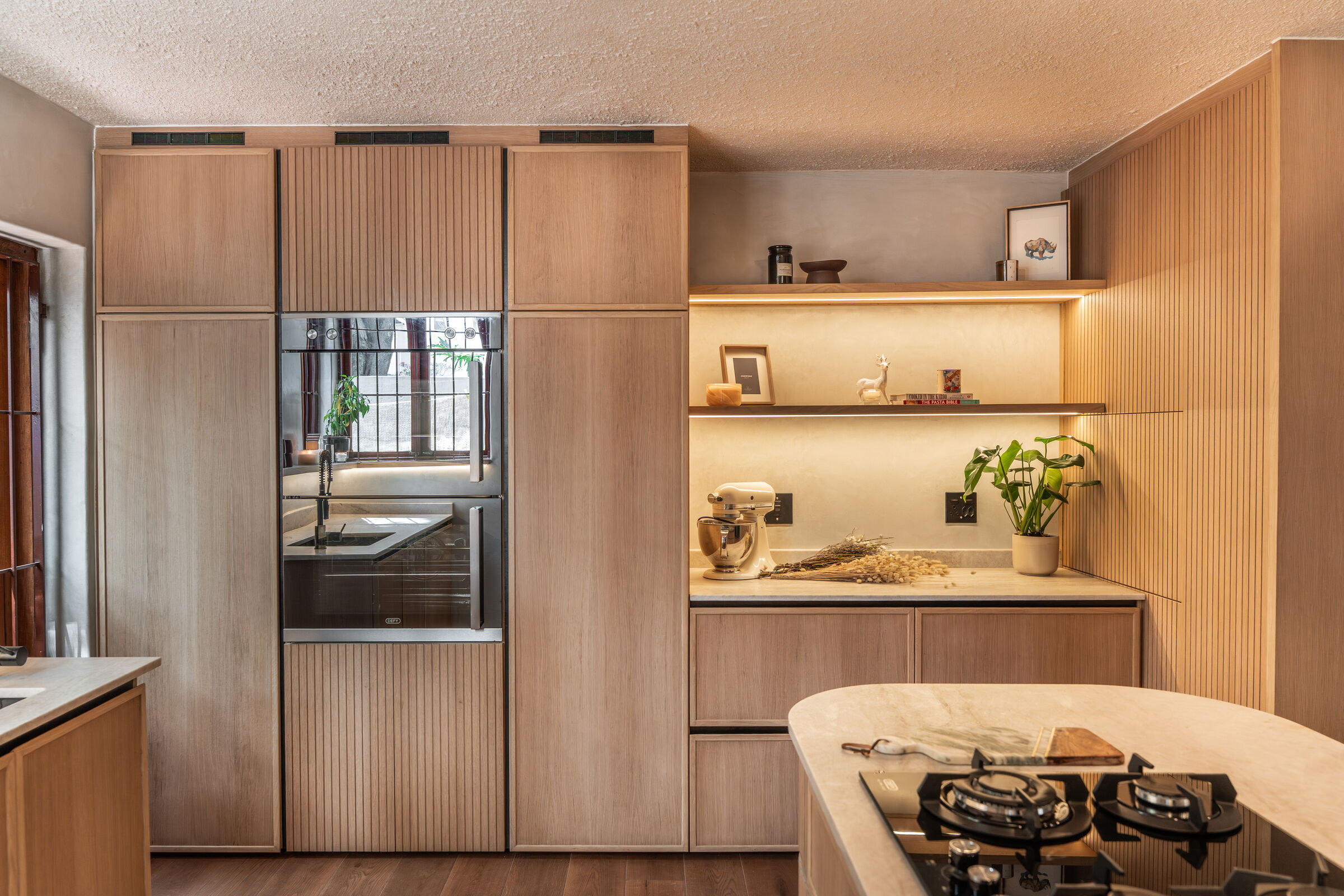 Bedford Park Residence — kitchen island in fluted oak, designed, manufactured and installed by The Kitchen Studio.