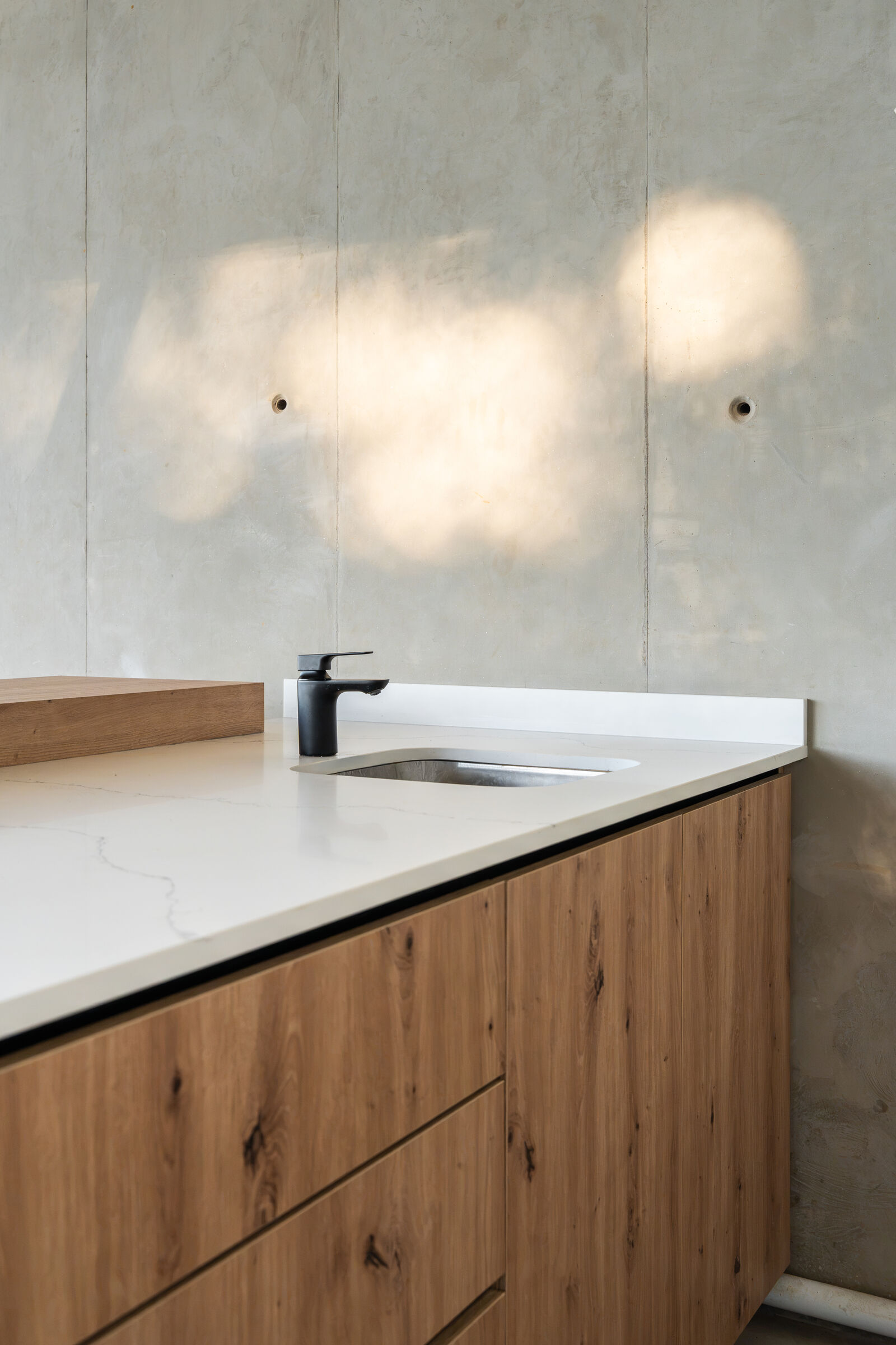 Northcliff Residence — timber vanity with stone top, designed, manufactured and installed by The Kitchen Studio.