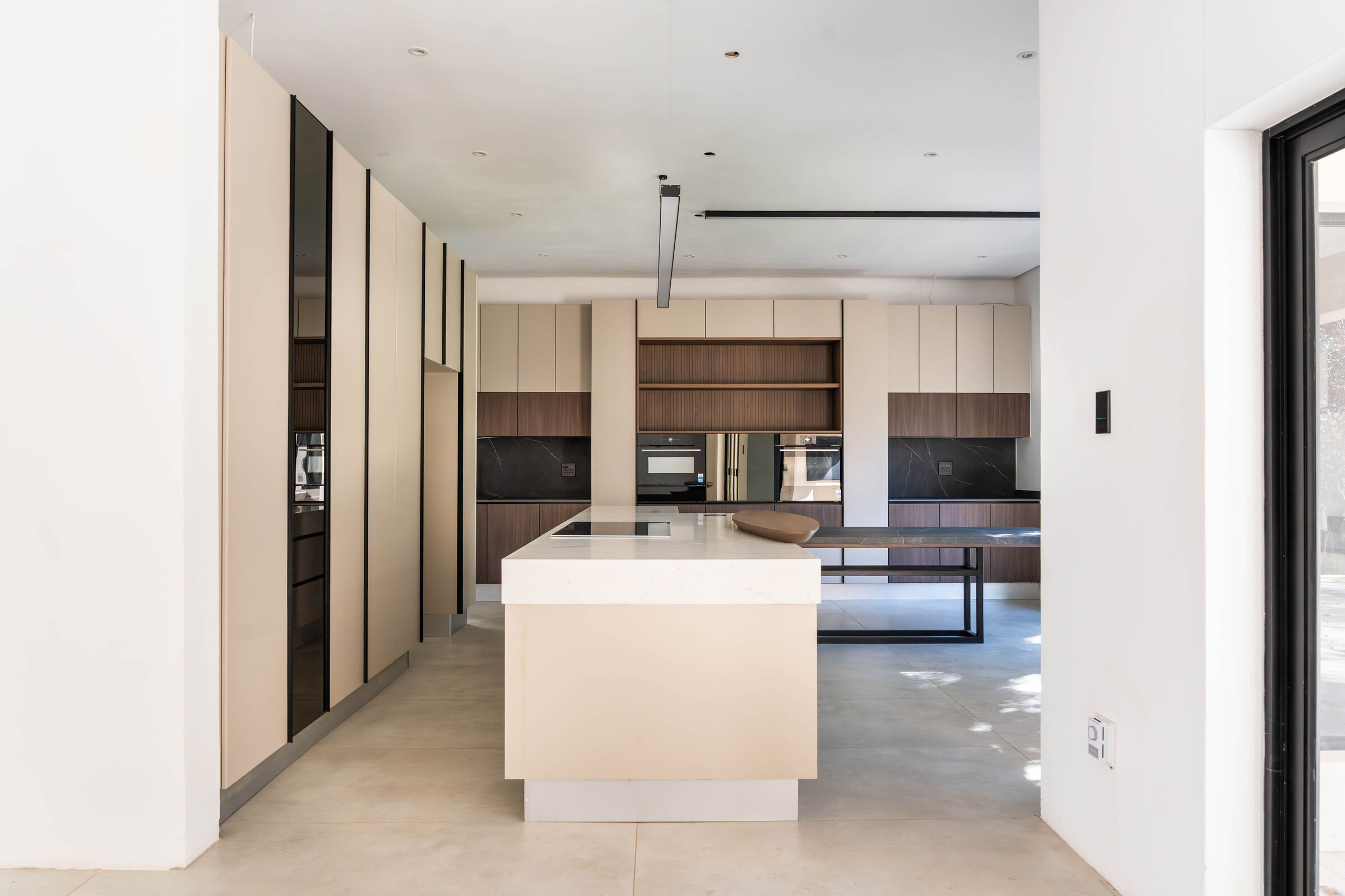 Greenside Residence — kitchen seen along the passage, designed, manufactured and installed by The Kitchen Studio.
