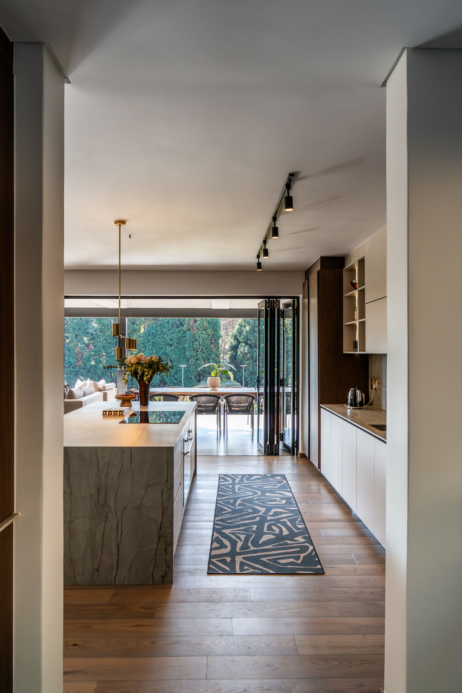 Westcliff Residence — kitchen seen through the passage, designed, manufactured and installed by The Kitchen Studio.
