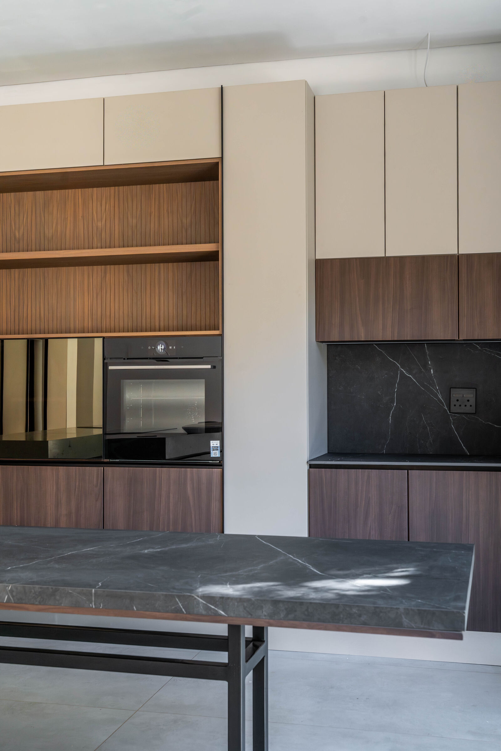 Greenside Residence — cooking run in dark stone, designed, manufactured and installed by The Kitchen Studio.